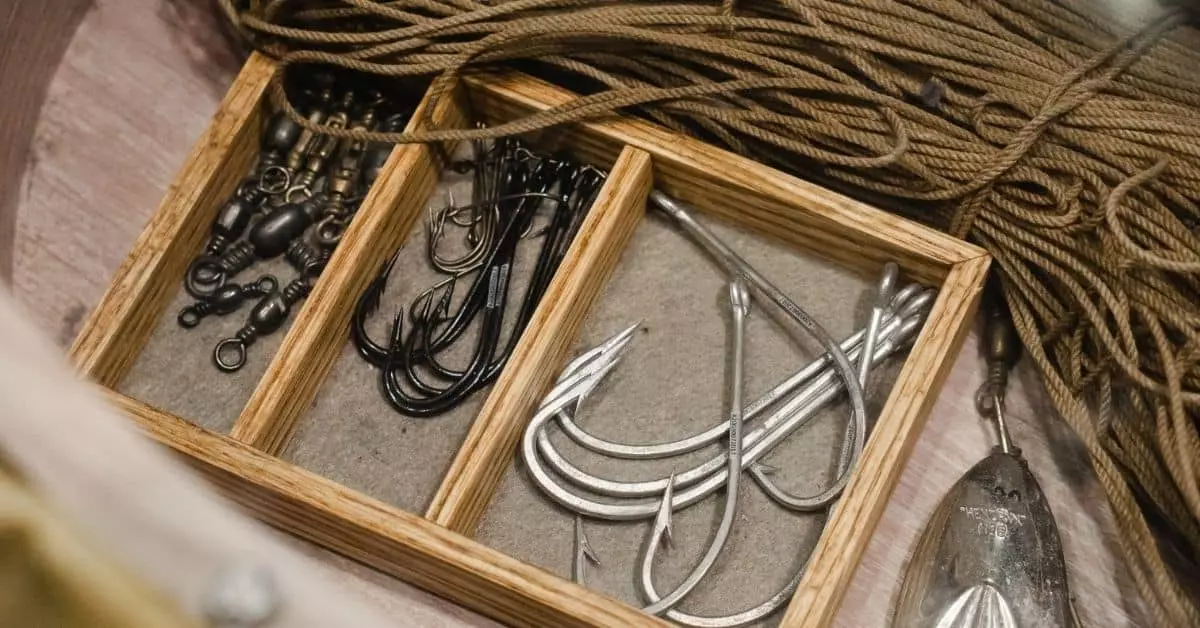 Collection of hooks in tackle box with string, used as a featured image.