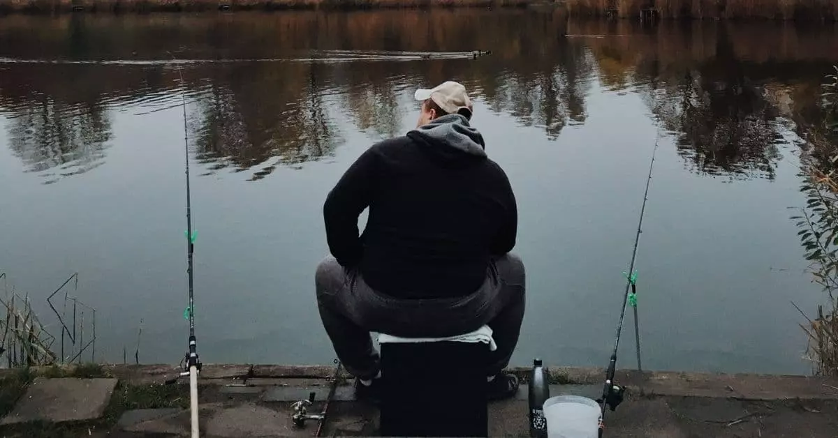 Man with multiple rods fishing for crappie on a lake
