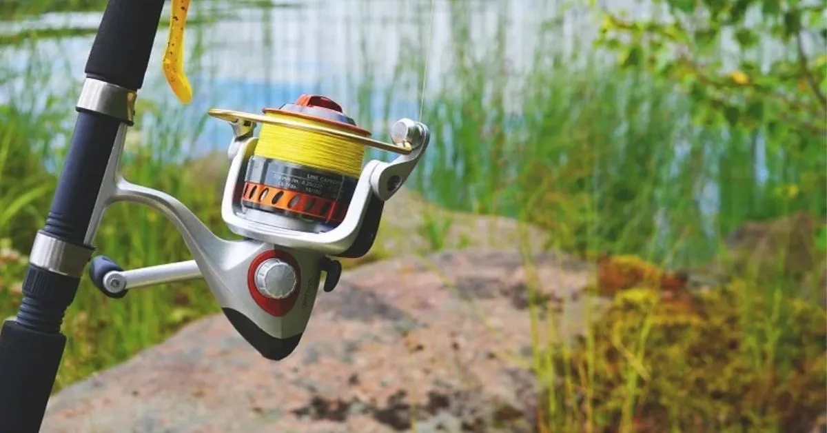Spinning reel spooled with high visibility line at a pond