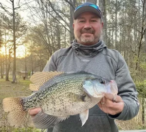 James King holding a large 3 lb crappie he caught.